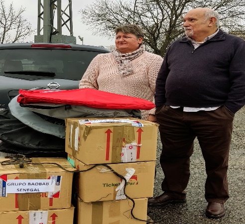 Two volunteers next to boxes of supplies for Baobab Senegal